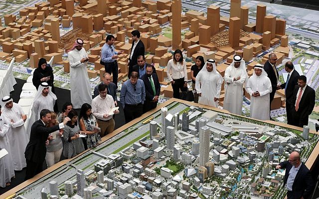 Journalists and Emirati officials listen to Morgan Parker, Chief Operating Officer of Dubai Holding, as he explains over the architectural model of the “Jumeriah Central” development, a US $ 20 billion project, during a press briefing in Dubai, United Arab Emirates, September 4, 2016. (AP Photo/Kamran Jebreili)