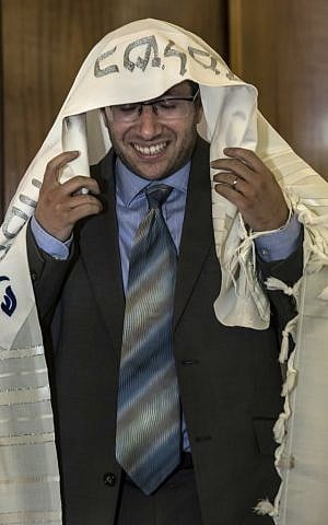 In this Wednesday, Sept. 14, 2016 photo, American-Israeli Arie Hasit, center, is ordained a rabbi at the Schechter Rabbinical Seminary in Jerusalem. (AP/Tsafrir Abayov)