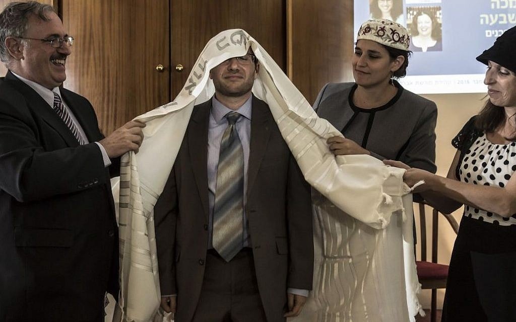 In this Wednesday, Sept. 14, 2016 photo, American-Israeli Arie Hasit, center, is ordained a rabbi at the Schechter Rabbinical Seminary in Jerusalem. (AP/Tsafrir Abayov) In this Wednesday, Sept. 14, 2016 photo, American-Israeli Arie Hasit, center, is ordained a rabbi at the Schechter Rabbinical Seminary in Jerusalem. (AP/Tsafrir Abayov)