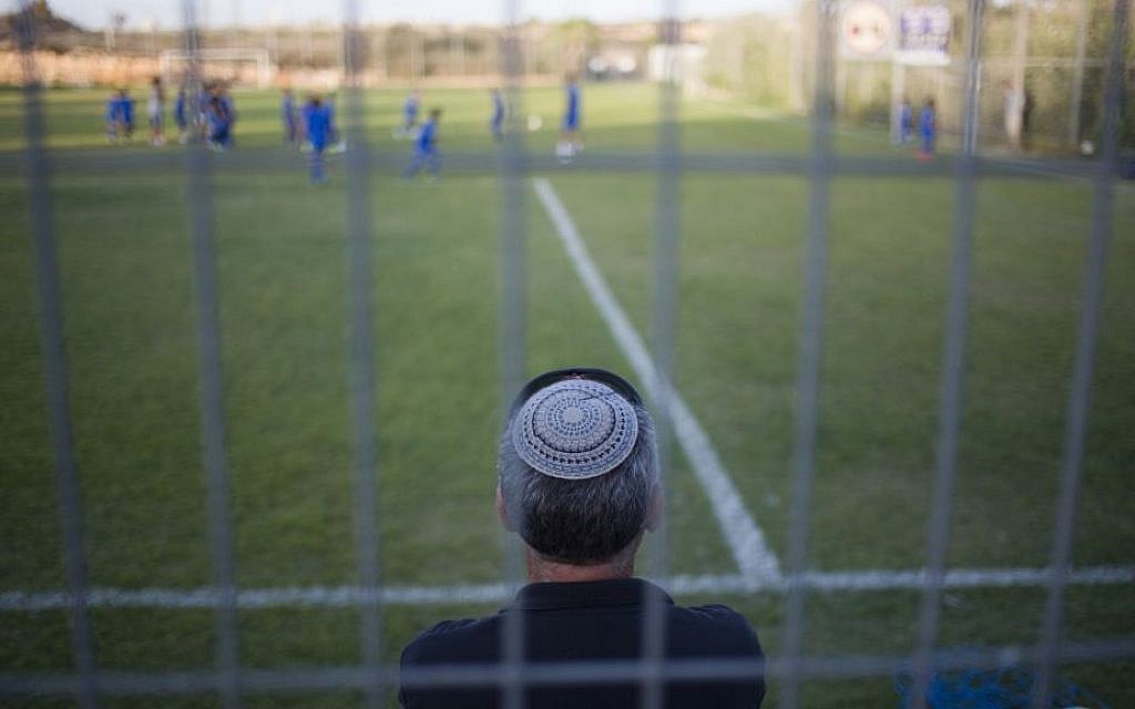 A man watches his son during a training session of the Beitar Shabi Givat Zeev soccer club, in the West Bank Jewish settlement of Givat Ze'ev, near Jerusalem, Thursday, Sept. 22, 2016. (AP Photo/Ariel Schalit) A man watches his son during a training session of the Beitar Shabi Givat Zeev soccer club, in the West Bank Jewish settlement of Givat Ze'ev, near Jerusalem, Thursday, Sept. 22, 2016. (AP Photo/Ariel Schalit)