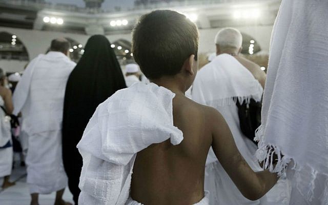 A child holds on to his father as he circles the Kaaba, Islam's holiest shrine, at the Grand Mosque in the Muslim holy city of Mecca, Saudi Arabia, Thursday, Sept. 8, 2016. (AP Photo/Nariman El-Mofty)