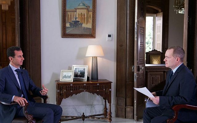 Syrian President Bashar Assad, left, speaks to Ian Phillips, Vice President, International News for The Associated Press, at the presidential palace in Damascus, September 21, 2016. (Syrian Presidency via AP)