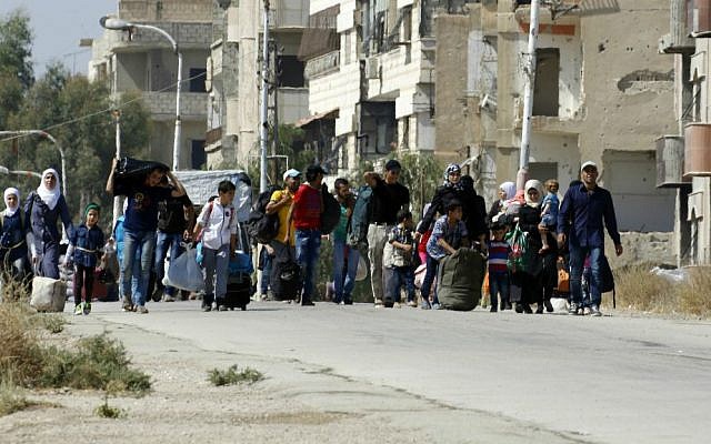 Syrians leave the Moadamiyeh suburb of Damascus, Syria, on Friday, Sept. 2, 2016. (AP Photo)