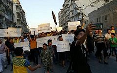 Activists in Syria’s besieged Aleppo protest against the United Nations for what they say is its failure to lift the siege off their rebel-held area, Tuesday, Sept. 13, 2016. (Modar Shekho via AP)