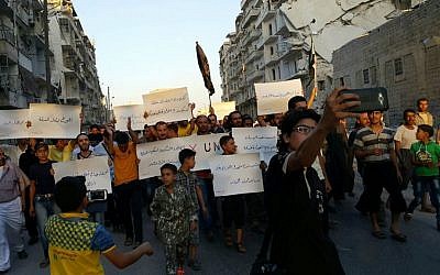 Activists in Syria’s besieged Aleppo protest against the United Nations for what they say is its failure to lift the siege off their rebel-held area, Tuesday, Sept. 13, 2016. (Modar Shekho via AP)