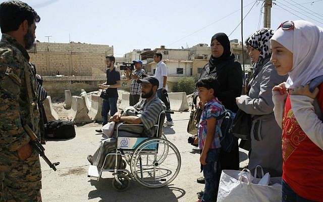 Syrians wait to board buses as they leave the Moadamiyeh suburb of Damascus, Syria, on Friday, Sept. 2, 2016. (AP Photo) Syrians wait to board buses as they leave the Moadamiyeh suburb of Damascus, Syria, on Friday, Sept. 2, 2016. (AP Photo)