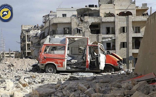 In this Friday, Sept. 23, 2016, file photo, in this photo provided by the Syrian Civil Defense group known as the White Helmets, a destroyed ambulance is seen outside the Syrian Civil Defense main center after airstrikes in Ansari neighborhood in the rebel-held part of eastern Aleppo, Syria. (Syrian Civil Defense White Helmets via AP)