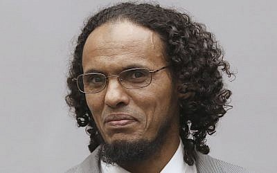 Ahmad Al Faqi Al Mahdi, right, a Malian Islamic extremist who pleaded guilty to destruction of historic mausoleums in Timbuktu, enters the court room to hear the verdict of the International Criminal Court in The Hague, Netherlands, Tuesday, September 27, 2016. (Bas Czerwinski POOL via AP)
