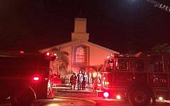 Firefighters work at the scene of a fire at the Islamic Center of Fort Pierce on Monday, September 12, 2016, in Fort Pierce, Florida (St. Lucie Sheriff's Office via AP)