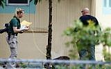 Investigators with the St. Lucie County Sheriff's Office work in a yard Monday, Sept. 12, 2016, at the Fort Pierce Islamic Center in Fort Pierce, Fla., after an apparent arsonist started a fire at the back of the center earlier that morning. (Adam Sacasa/South Florida Sun-Sentinel via AP)
