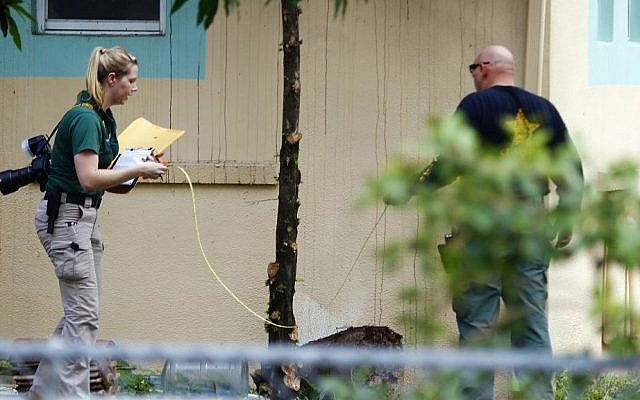 Investigators with the St. Lucie County Sheriff's Office work in a yard Monday, Sept. 12, 2016, at the Fort Pierce Islamic Center in Fort Pierce, Fla., after an apparent arsonist started a fire at the back of the center earlier that morning. (Adam Sacasa/South Florida Sun-Sentinel via AP) Investigators with the St. Lucie County Sheriff's Office work in a yard Monday, Sept. 12, 2016, at the Fort Pierce Islamic Center in Fort Pierce, Fla., after an apparent arsonist started a fire at the back of the center earlier that morning. (Adam Sacasa/South Florida Sun-Sentinel via AP)
