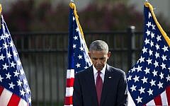 President Barack Obama bows his head for a moment of silence before delivering remarks at the Sept. 11 memorial observance ceremony at the Pentagon, Sunday, Sept. 11, 2016. (AP/Cliff Owen)