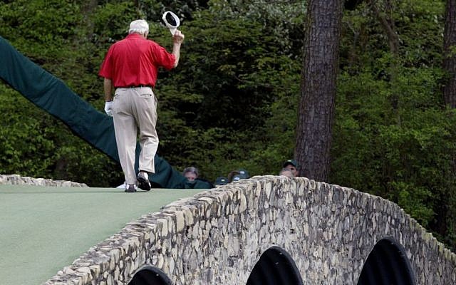 Arnold Palmer walking across the Hogan Bridge on the 12th fairway for the final time in Masters competition during the second round of the Masters golf tournament at the Augusta National Golf Club in Augusta, Ga, April 9, 2004. (AP/Amy Sancetta, File)