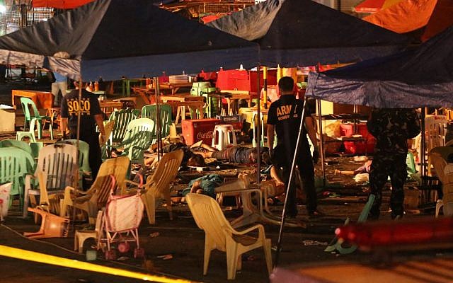 Philippine police officers stand beside bodies of victims after an explosion at a night market that has left about 14 people dead and wounded several others in southern Davao city, Philippines late Friday Sept. 2, 2016 (AP/Manman Dejeto) Philippine police officers stand beside bodies of victims after an explosion at a night market that has left about 14 people dead and wounded several others in southern Davao city, Philippines late Friday Sept. 2, 2016 (AP/Manman Dejeto)