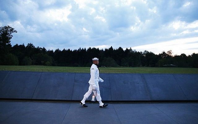 Candles in memory of the passengers and crew of Flight 93, are carried to the Wall of Names at the Flight 93 National Memorial in Shanksville, Pa, Saturday, Sept. 10, 2016, as the nation marks the 15th anniversary of the Sept. 11 attacks. (AP/Jared Wickerham) 