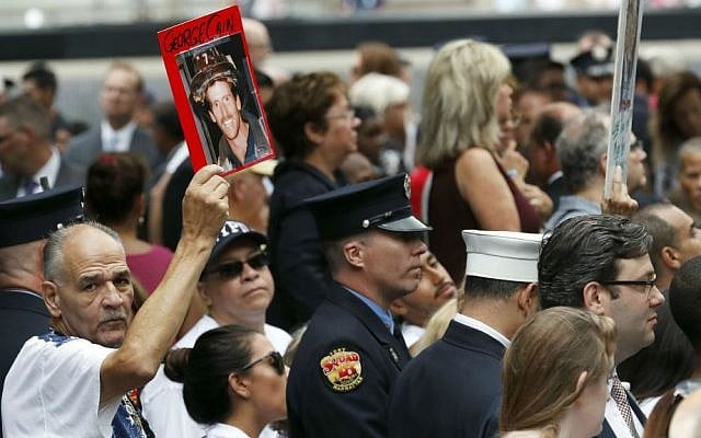 A mourner holds a photo of a loved one during the 15th anniversary of the attacks on the World Trade Center at the National September 11 Memorial, Sunday, Sept. 11, 2016, in New York. (AP Photo/Mary Altaffer) A mourner holds a photo of a loved one during the 15th anniversary of the attacks on the World Trade Center at the National September 11 Memorial, Sunday, Sept. 11, 2016, in New York. (AP Photo/Mary Altaffer)