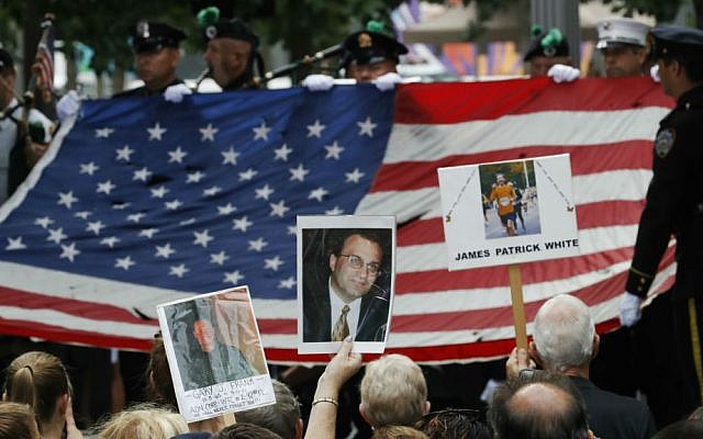 Mourners hold photos of their loved ones during the 15th anniversary of the attacks on the World Trade Center at the National September 11 Memorial, Sunday, Sept. 11, 2016, in New York. (AP Photo/Mary Altaffer) Mourners hold photos of their loved ones during the 15th anniversary of the attacks on the World Trade Center at the National September 11 Memorial, Sunday, Sept. 11, 2016, in New York. (AP Photo/Mary Altaffer)