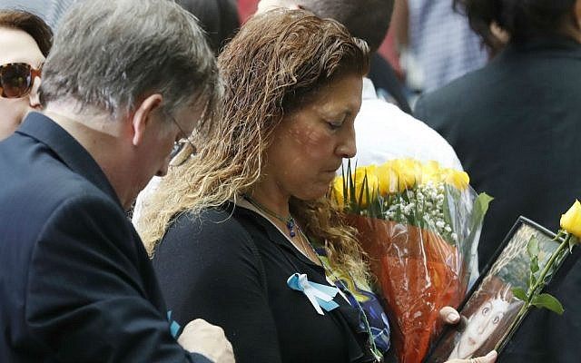 A mourner holds a photo of her loved one during the 15th anniversary of the attacks on the World Trade Center at the National September 11 Memorial, Sunday, Sept. 11, 2016, in New York. (AP Photo/Mary Altaffer) A mourner holds a photo of her loved one during the 15th anniversary of the attacks on the World Trade Center at the National September 11 Memorial, Sunday, Sept. 11, 2016, in New York. (AP Photo/Mary Altaffer)