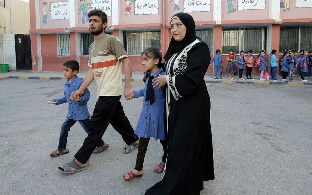 In this Thursday, Sept. 1, 2016 photo, a Syrian refugee family brings their children to school in Amman, Jordan. (AP Photo/Ahmad Alameen) In this Thursday, Sept. 1, 2016 photo, a Syrian refugee family brings their children to school in Amman, Jordan. (AP Photo/Ahmad Alameen)