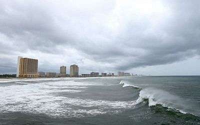 Waves break in the water as rain driven by Hurricane Hermine moves in near the County Pier, Thursday, Sept. 1, 2016, in Panama City Beach, Florida. (Patti Blake/News Herald via AP)