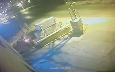 Video footage appears to show Israeli soldiers torch a Palestinian storehouse (screen capture: Channel 2)