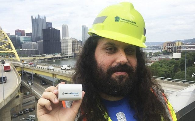 Waze system operation engineer Gil Disatnik holds a Waze beacon in Pittsburgh, where the beacons have been installed in two tunnels, September 8, 2016. (Meghan Kelleher/Courtesy of Waze via AP) Waze system operation engineer Gil Disatnik holds a Waze beacon in Pittsburgh, where the beacons have been installed in two tunnels, September 8, 2016. (Meghan Kelleher/Courtesy of Waze via AP)