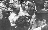Defense Minister Shimon Peres (r) with Prime Minster Yitzhak Rabin welcoming the released Entebbe hostages upon their return to Israel on July 4, 1976. (Defense Ministry Archives)