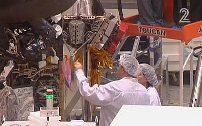 Workers for Israel Aerospace Industries building the Amos-6 satellite, in footage aired September 1, 2016. (screen capture: Channel 2) Workers for Israel Aerospace Industries building the Amos-6 satellite, in footage aired September 1, 2016. (screen capture: Channel 2)