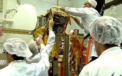 Workers for Israel Aerospace Industries building the Amos-6 satellite, in footage aired September 1, 2016. (screen capture: Channel 2)