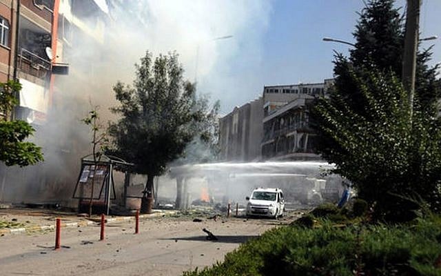Firefighters work to extinguish a fire after a car bomb attack in the city center of Van, eastern Turkey, Monday, Sept. 12, 2016. (DHA via AP)