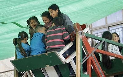 Young Arab children seen riding a ferris wheel in the Muslim Quarter of Jerusalem's Old City during the Muslim holiday of Eid El Adha. (Miriam Alster/FLASH90)