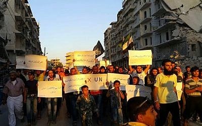 Activists in the besieged Syrian city of Aleppo protest against the UN for what they say is its failure to lift the siege off their rebel-held area, on Sept. 13, 2016. (Modar Shekho via AP)