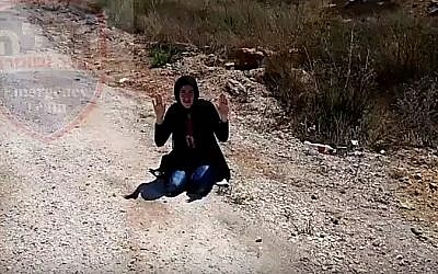 A woman carrying a knife is arrested outside the West Bank settlement of Itamar on September 18, 2016 (YouTube screenshot)