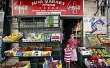 Two young girls eat ice cream as they leave a mini market in Jerusalem, August 2, 2010. (Miriam Alster/Flash90)