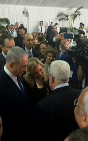 Prime Minister Benjamin Netanyahu and Palestinian Authority President Mahmoud Abbas speak at the funeral of Shimon Peres in Jerusalem on September 30, 2016. (screen capture: Channel 2)