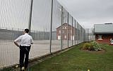 Illustrative: A prison guard of Premier Custodial Services patrols the security fencing of Kilmarnock Prison on 26 April, 2005, Kilmarnock, Scotland. (Christopher Furlong/Getty Images)