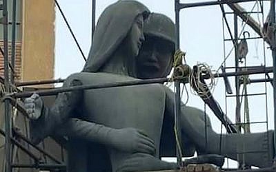 A sculpture, entitled Mother of the Martyr, depicts a slender peasant woman, representing Egypt, with a helmeted soldier standing behind her, Sohag, Egypt, August 2016. (AP Photo/Mahmoud Ahmed)