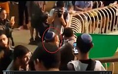 Lehava leader Bentzi Gopstein (circled in red) arguing with a police officer at a choir performance in Jerusalem on September 22 2016. (screen capture: Channel 10)