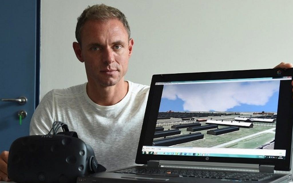 Ralf Breker of the Bavarian criminal police posing in Munich with virtual reality glasses and a computer which shows a picture from the 3D model of the former Nazi concentration camp Auschwitz, September 26, 2016. (AFP/Christof Stache) Ralf Breker of the Bavarian criminal police posing in Munich with virtual reality glasses and a computer which shows a picture from the 3D model of the former Nazi concentration camp Auschwitz, September 26, 2016. (AFP/Christof Stache)
