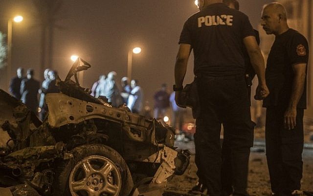 Egyptian policemen inspect the wreckage of a car bomb that exploded in a Cairo suburb after Egypt's deputy prosecutor general drove by late on September 29, 2016, wounding a passerby. (AFP/Khaled Desouki) Egyptian policemen inspect the wreckage of a car bomb that exploded in a Cairo suburb after Egypt's deputy prosecutor general drove by late on September 29, 2016, wounding a passerby. (AFP/Khaled Desouki)