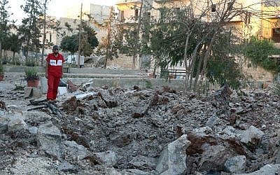 A Syrian medical staff member inspects the damage at the site of a medical facility after it was reportedly hit by Syrian regime barrel bombs on October 1, 2016, in the rebel-held neighborhood of al-Sakhour, in the northern city of Aleppo. (AFP PHOTO / THAER MOHAMMED)