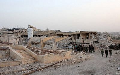 Syrian regime forces gather at the bombed-out Kindi Hospital in Aleppo on October 2, 2016. (George Ourfalian/AFP)