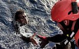 A migrant is rescued from the mediteranean sea by a member of Proactiva Open Arms NGO some 20 nautical miles north of Libya on October 3, 2016. 
(Aris Messinis/AFP)