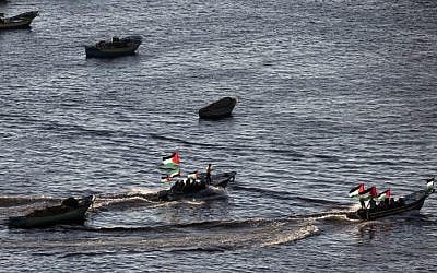Palestinians sail boats bearing their national flag in the port of Gaza City in support of the Gaza-bound flotilla of international female activists attempting to break the Israeli blockade on the Hamas-run Gaza Strip on October 5, 2016. (AFP/Mahmud Hams)