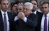Illustrative: Palestinian Authority President Mahmoud Abbas, center, waves as he is escorted out of the Istishari Hospital in the West Bank city of Ramallah on October 6, 2016, following his discharge. (AFP/Abbas Momani)