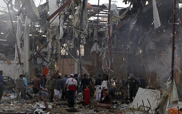 A picture taken on October 8, 2016 shows Yemenis and rescue teams gather at the site of reported airstrikes by Saudi-led coalition air-planes in the capital Sanaa. (AFP/Mohammed Huwais) A picture taken on October 8, 2016 shows Yemenis and rescue teams gather at the site of reported airstrikes by Saudi-led coalition air-planes in the capital Sanaa. (AFP/Mohammed Huwais)
