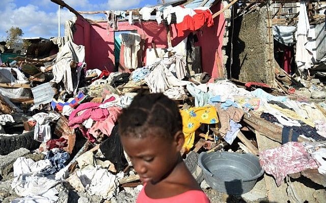 A girl walks in a beach next to the debris left by Hurricane Matthew, in Jeremie, Haiti, on October 8, 2016. (AFP PHOTO / HECTOR RETAMAL) A girl walks in a beach next to the debris left by Hurricane Matthew, in Jeremie, Haiti, on October 8, 2016. (AFP PHOTO / HECTOR RETAMAL)