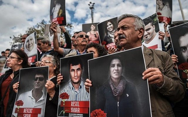 People shout slogans and hold up poster pictures of victims killed in the October 10, 2015 blasts in Ankara as they mark the first year anniversary of the attacks during a demonstration on October 9, 2016 in Istanbul's Kadikoy district. (AFP Photo/Ozan Kose) People shout slogans and hold up poster pictures of victims killed in the October 10, 2015 blasts in Ankara as they mark the first year anniversary of the attacks during a demonstration on October 9, 2016 in Istanbul's Kadikoy district. (AFP Photo/Ozan Kose)