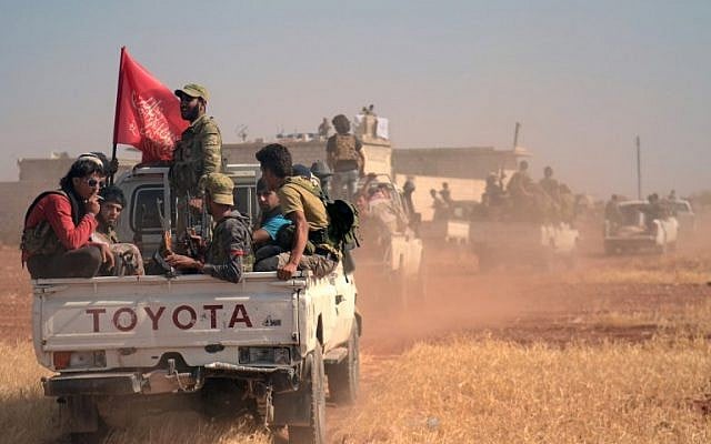 Fighters from the Free Syrian Army fire an anti-aircraft machine gun mounted on a vehicle deploy during fighting against the Islamic State (IS) group jihadists in the northern Syrian village of Yahmoul in the Marj Dabiq area north of the embattled city of Aleppo on October 10, 2016.(AFP PHOTO / Nazeer al-Khatib)