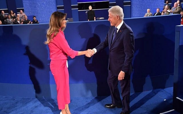 Former President Bill Clinton, right, greets Melania Trump, wife of Republican presidential candidate Donald Trump, before the start of the second presidential debate at Washington University in St. Louis, Missouri, October 9, 2016. (AFP/Paul J. Richards)